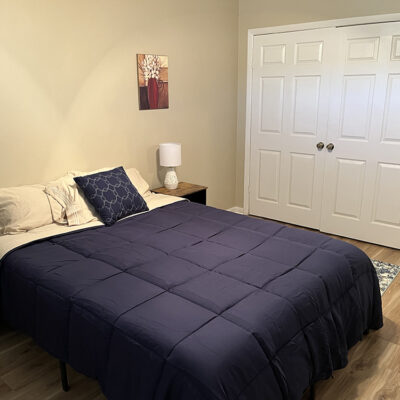 apartment bedroom with blue comforter