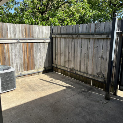 fenced concrete slab patio